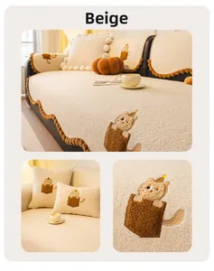 Detail of beige teddy plush sofa cover featuring cat embroidery and wavy pom-pom edges