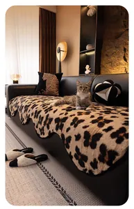 Macro detail of plush leopard print sofa cover with wavy edges and matching pillow