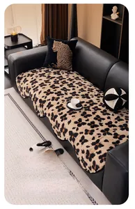 Detail of plush leopard print sofa cover with soft faux fur texture and black piping