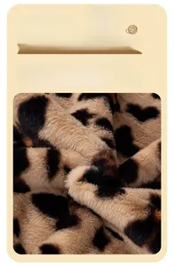 Close-up of thick leopard print plush fabric with high-density warm faux fur texture