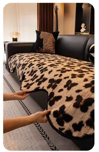 Detailed view of leopard print plush sofa cover with thick texture and black piping