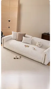 Detail of cream white sofa cover with textured grid pattern and soft velvet fabric