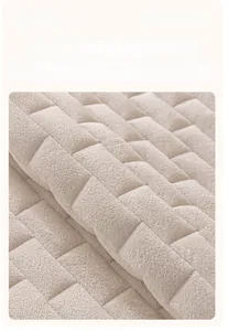Detail of premium thick crystal velvet sofa cover with quilted brick pattern in beige