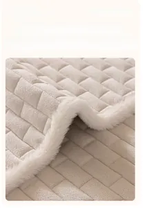 Detail of cream crystal velvet sofa cover showing square quilting and plush fur edges