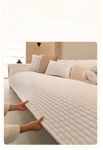 Close-up of thick crystal velvet sofa cover with quilted square texture in cream white