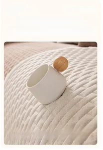Detail of cream crystal velvet sofa cover with anti-slip silicone particles on back