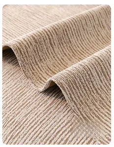 Detail of khaki sofa cover showing thick textured fabric and refined edge stitching