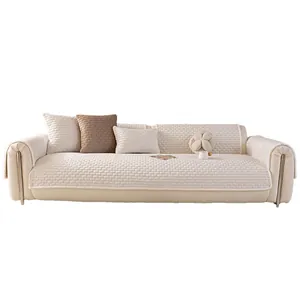 Thick cream-colored crystal velvet sofa cover with quilted pattern and floral pillows