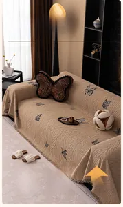 Detailed macro view of beige rabbit plush sofa cover with 3D butterfly floral textures