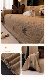 Detail of dark coffee thick fabric sofa cover with butterfly embroidery and tassels