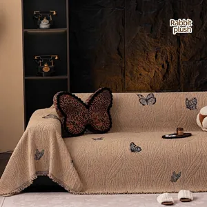 Luxurious beige butterfly pattern plush sofa cover with elegant tassel edge detail