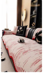 Detail of red and cream chenille sofa cover showing the 3D woven texture and floral cushions