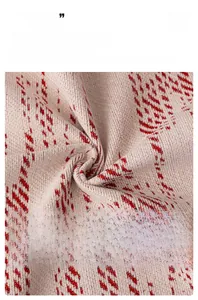 Macro detail of breathable beige chenille fabric with red patterns and soft texture
