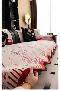 Detail of irregular chenille sofa cover with geometric patterns and wavy black edges