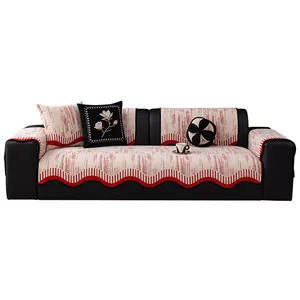 Nonslip beige chenille sofa cover with red wavy trim and embroidered floral cushions