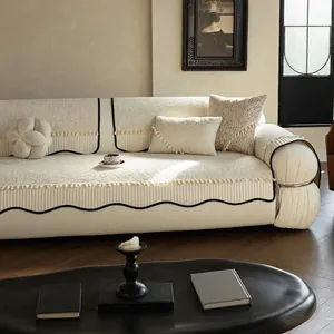 Cream white chenille sofa cover with fringed edges and black wavy trim for home decor