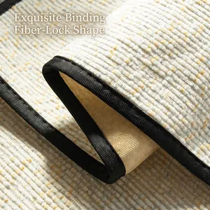 Close-up of beige chenille sofa cover with black edge piping and striped plush texture