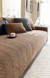 Detail of chenille sofa cushion with leaf texture in cream-colored modern home decor