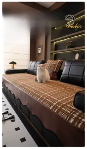 Detail of chenille sofa cover with brown checkered pattern and cat in a cozy living room