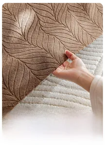 Close-up of thick non-slip sofa cover fabric with brown leaf texture and elastic recovery