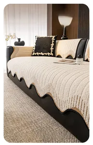 Detail of cream chenille sofa cover with vertical quilting and elegant wavy edges