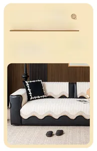 Detail of minimalist cream sofa cover with wavy edges and brown embroidered stitching