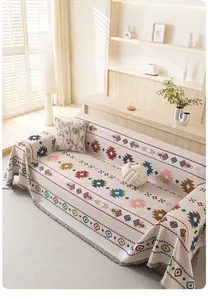 Close-up of Bohemian sofa blanket with colorful geometric weaving and fringe details