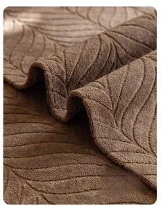 Detail of dark brown sofa cover featuring 3D leaf texture and durable stitched edges