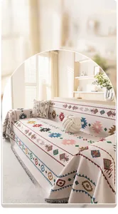 Detail of bohemian geometric woven sofa throw with fringe in cream cotton fabric