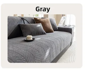 Close-up of grey chenille sofa cover with thick feather-like texture and matching pillow
