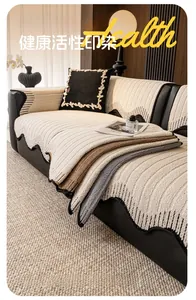 Detail of plush velvet sofa cushions with striped texture and scalloped black edges