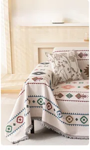 Detail of bohemian geometric sofa throw with heavy jacquard texture and fringed edges