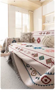 Detail of bohemian geometric sofa throw with thick jacquard texture and decorative tassels