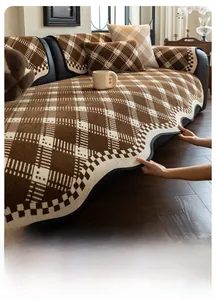 Macro detail of brown checkered chenille sofa cover featuring scalloped edges and thick texture