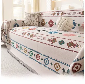 Detail of bohemian sofa throw blanket featuring colorful geometric patterns and fringe