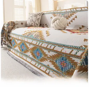 Detail of bohemian sofa cover featuring colorful geometric patterns and grey tassels