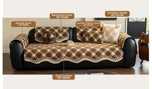 Detail view of scalloped edge on brown checkered chenille sofa cover set on leather couch