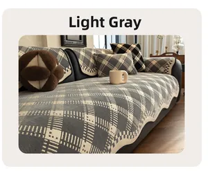 Detailed view of light grey chenille sofa cover with woven diamond pattern and wavy edges