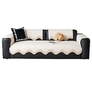 Minimalist beige plush sofa cushion set with wave borders on a black leather couch