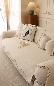 Close-up of thick cream chenille sofa cover showing texture and elegant fringe details