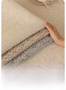 Close-up of three premium chenille fabrics with textured stripes in grey and beige