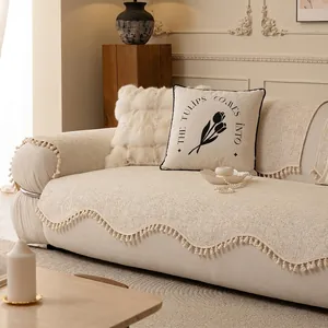 Minimalist cream chenille sofa cover with wavy edges and decorative ball tassels