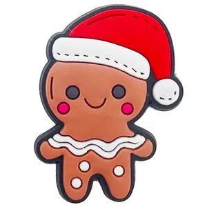 Detailed close-up of a gingerbread man PVC shoe charm with a red Christmas hat