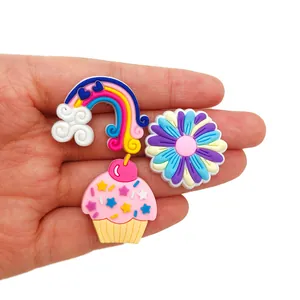 Three-piece cute shoe charm set featuring a rainbow, daisy flower, and pink cupcake charm