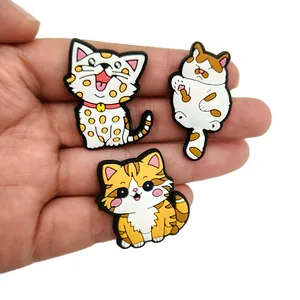 Three cute PVC cat shoe charms for clogs, including calico and orange striped kittens