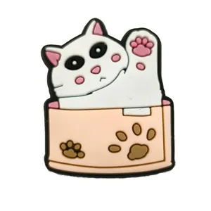 Detail showing a cute PVC cat charm and paw print accessory for garden clogs