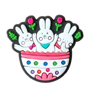 Detailed view of PVC Easter bunny charms in a colorful basket for garden clog shoes