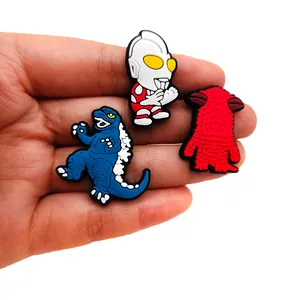 Detailed PVC shoe charms featuring Ultraman and Godzilla characters for clogs and sandals