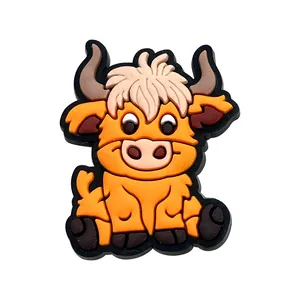 Close-up of cute 3D orange Highland cow PVC shoe charm with layered rubber texture