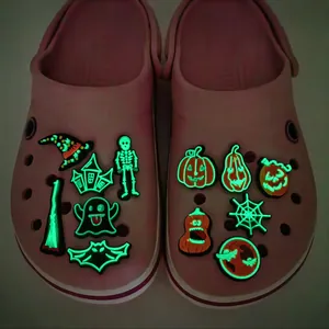Halloween glow-in-the-dark shoe charms set featuring ghosts and pumpkins on pink clogs